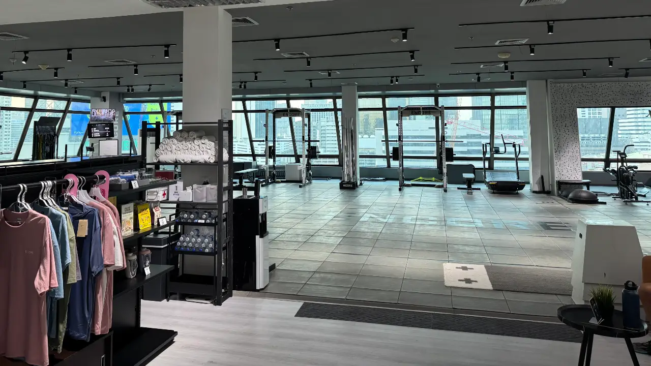 The weights floor at Encore Training Club in Sathorn, with squat racks along a wall of windows looking over Bangkok